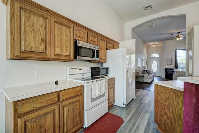 kitchen with ceiling fan, light hardwood / wood-style floors, stove, and white fridge with ice dispenser