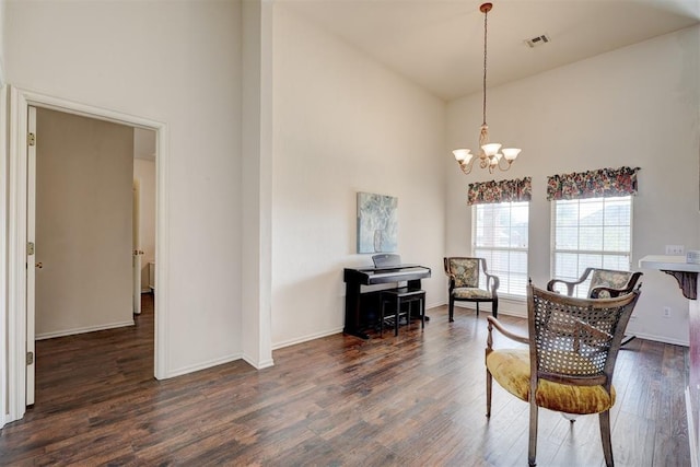 sitting room featuring a chandelier, dark hardwood / wood-style flooring, and high vaulted ceiling