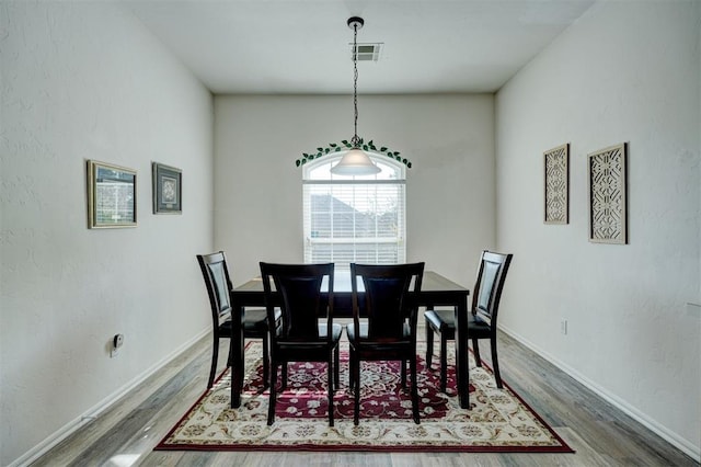 dining area with hardwood / wood-style floors