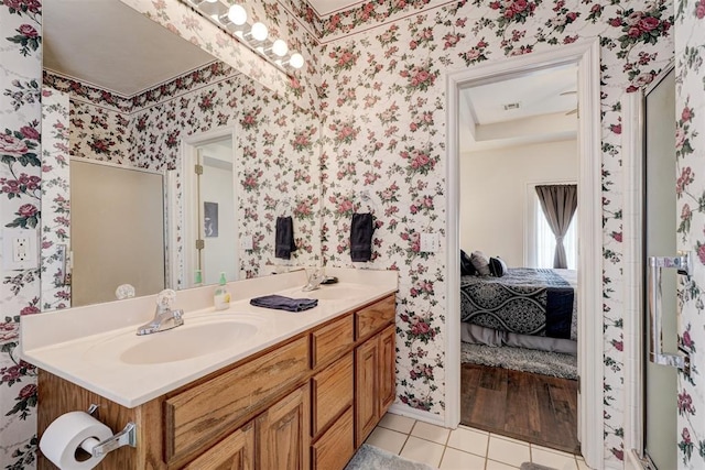 bathroom featuring tile patterned flooring, vanity, and walk in shower