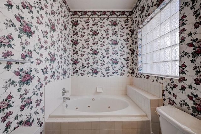 bathroom featuring a relaxing tiled tub and toilet