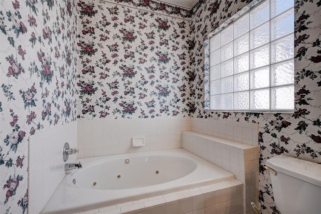 bathroom with tiled bath and toilet