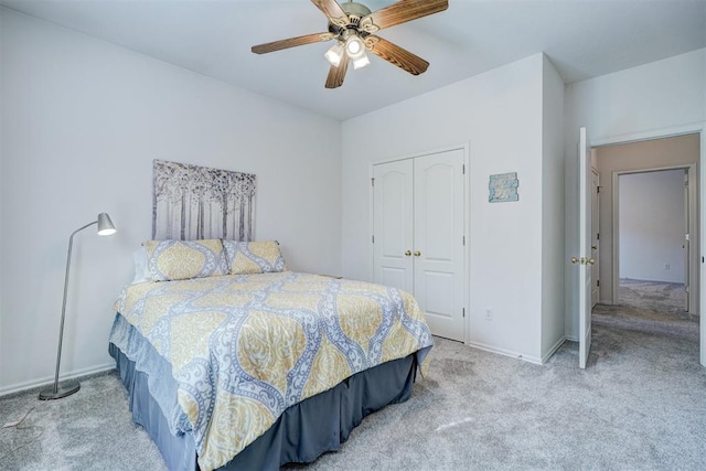 carpeted bedroom with a closet and ceiling fan