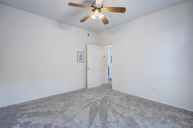 empty room featuring carpet flooring and ceiling fan