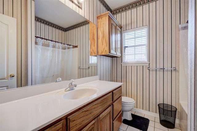 full bathroom featuring tile patterned flooring, vanity, toilet, and shower / tub combo