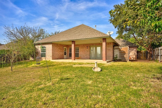 rear view of house with a lawn and a patio area