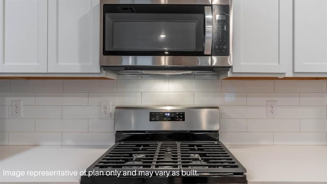 13581 Hickory Way, Edmond, OK 73025 - kitchen view of appliances with stainless steel finishes, light countertops, white cabinetry, and tasteful backsplash