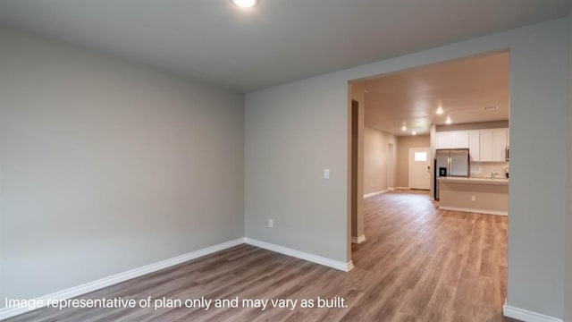 13581 Hickory Way, Edmond, OK 73025 - spare room featuring baseboards, light wood-type flooring, and recessed lighting