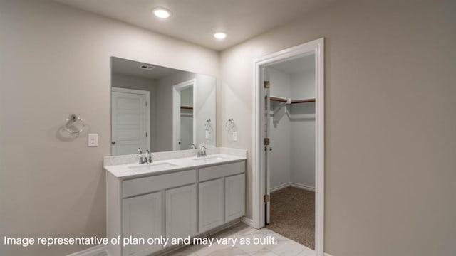 13581 Hickory Way, Edmond, OK 73025 - bathroom featuring double vanity, a walk in closet, baseboards, and recessed lighting