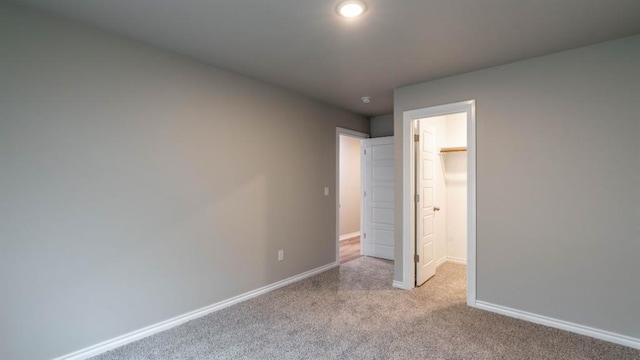 13581 Hickory Way, Edmond, OK 73025 - unfurnished bedroom featuring carpet, baseboards, and a walk in closet