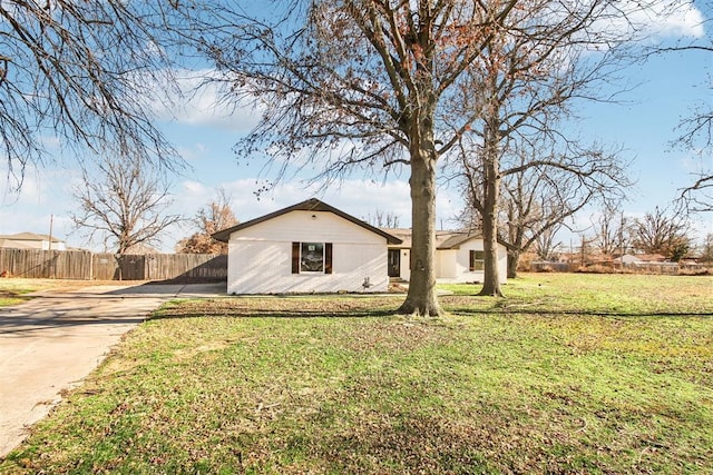 exterior space featuring a yard, fence, and driveway