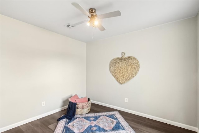 living area featuring a ceiling fan, baseboards, visible vents, and dark wood-style flooring