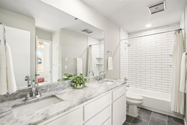 bathroom featuring a sink, visible vents, and tile patterned floors