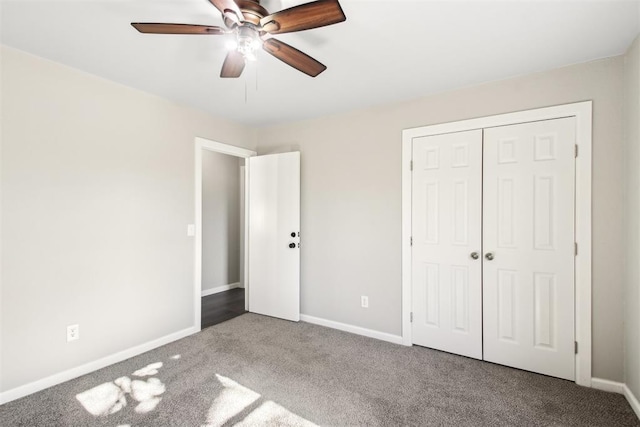 unfurnished bedroom with a ceiling fan, a closet, baseboards, and carpet flooring