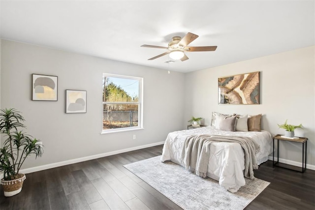 bedroom with baseboards, dark wood finished floors, and a ceiling fan