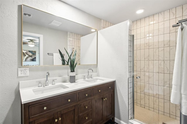 bathroom with a walk in shower, double vanity, a sink, and visible vents