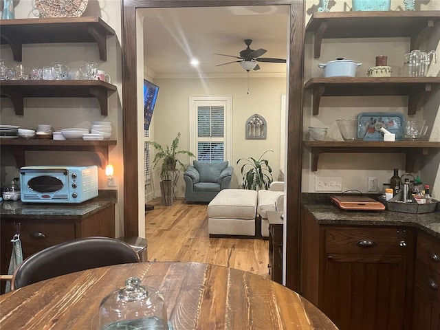 living area featuring light hardwood / wood-style floors, ceiling fan, and crown molding