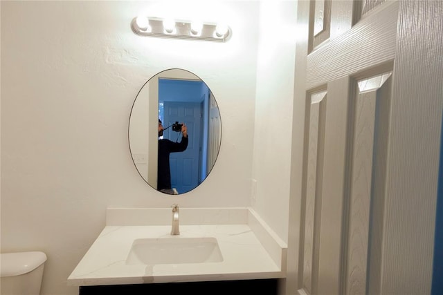 bathroom featuring toilet and vanity