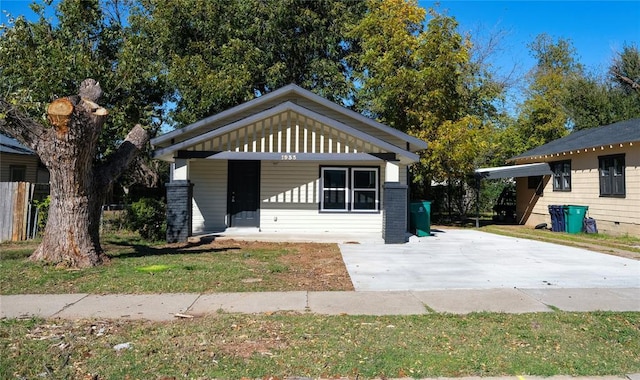 bungalow-style home with a front lawn and a porch