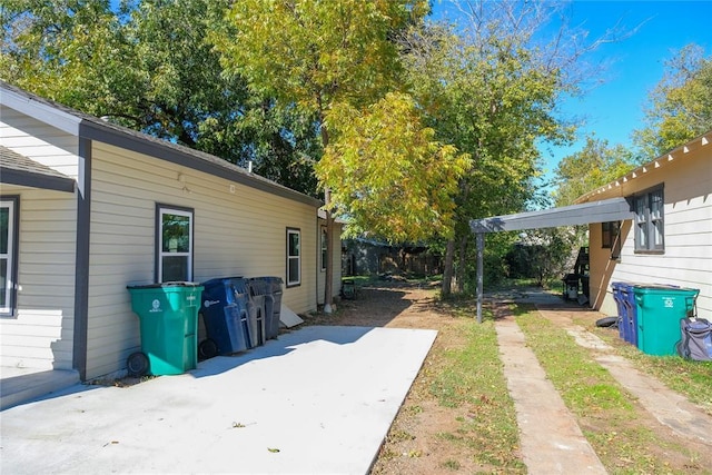 view of side of home with a patio area