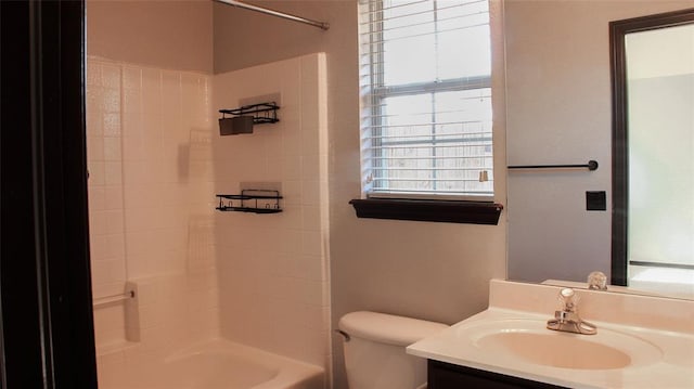 full bathroom featuring vanity, a healthy amount of sunlight, shower / bathtub combination, and toilet