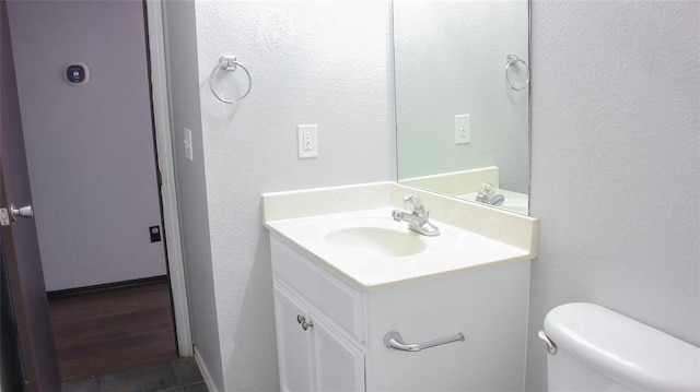 bathroom with vanity and toilet