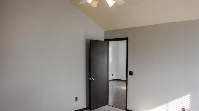 empty room featuring ceiling fan and lofted ceiling