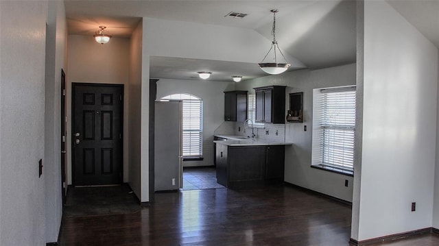 kitchen with decorative backsplash, dark hardwood / wood-style flooring, sink, hanging light fixtures, and lofted ceiling