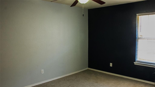 carpeted spare room with ceiling fan