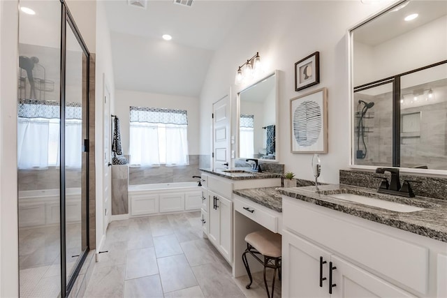 full bath with lofted ceiling, a shower stall, vanity, and a bath