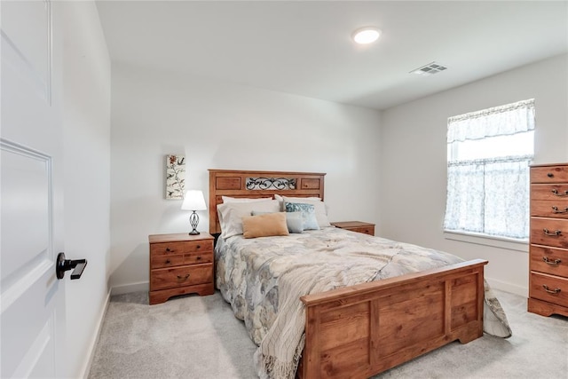 bedroom featuring light carpet, visible vents, and baseboards