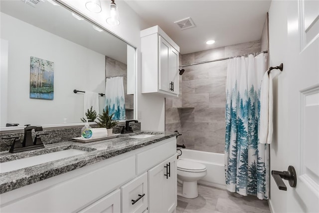 full bathroom featuring double vanity, visible vents, a sink, and shower / bath combo with shower curtain