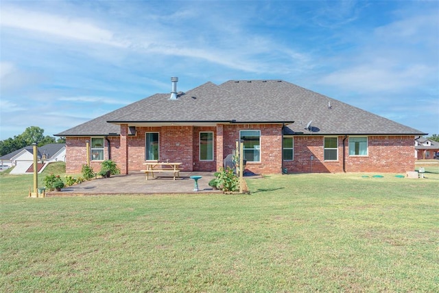 back of house with a patio area, a shingled roof, brick siding, and a yard