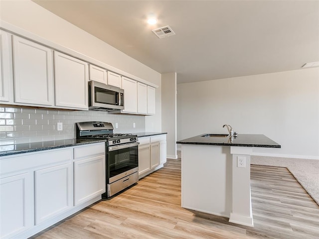 13074 Mannington Rd, Edmond, OK 73025 - kitchen with stainless steel appliances, dark stone counters, and backsplash