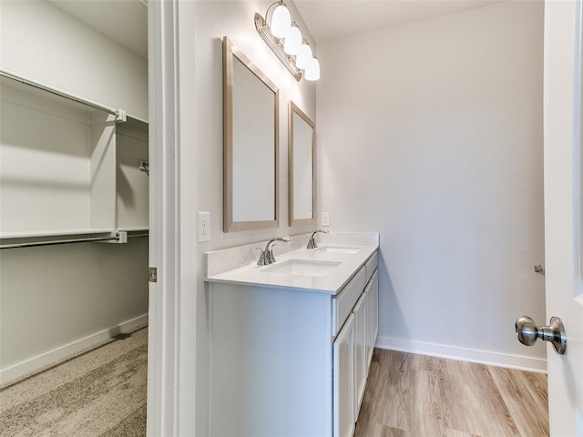 13074 Mannington Rd, Edmond, OK 73025 - bathroom with double vanity and wood finished floors