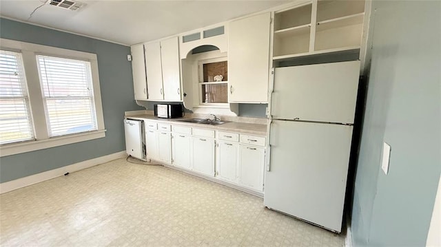 kitchen with white cabinetry, sink, and white appliances