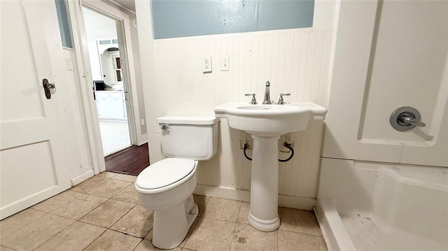 bathroom featuring tile patterned flooring, toilet, and sink