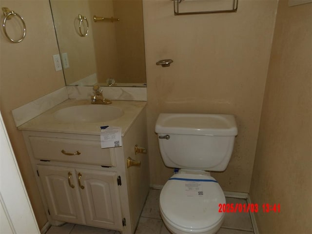 bathroom featuring tile patterned flooring, vanity, and toilet