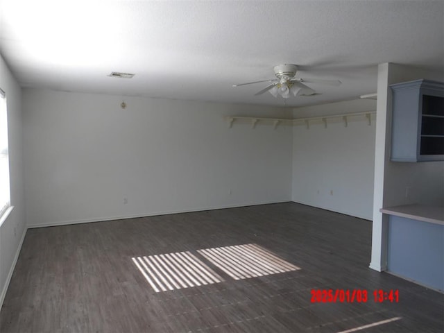 spare room with ceiling fan and dark wood-type flooring