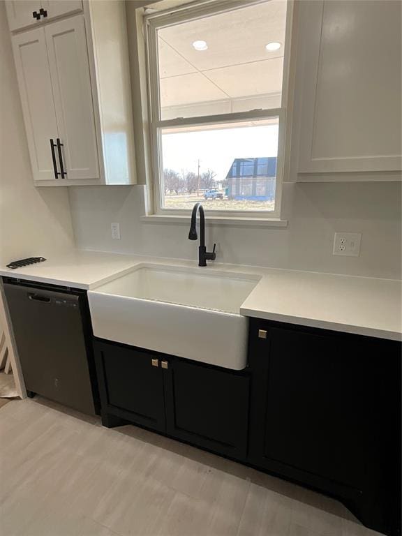 kitchen featuring white cabinetry, sink, and dishwasher