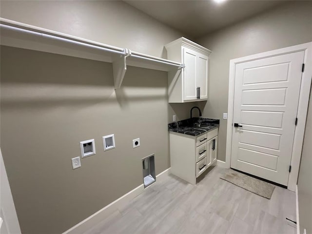 clothes washing area featuring hookup for a washing machine, baseboards, hookup for an electric dryer, light wood-style flooring, and cabinet space