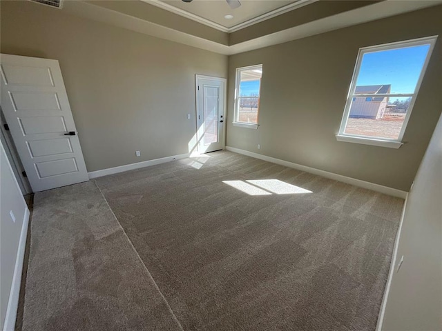 spare room with carpet floors, a ceiling fan, baseboards, and crown molding