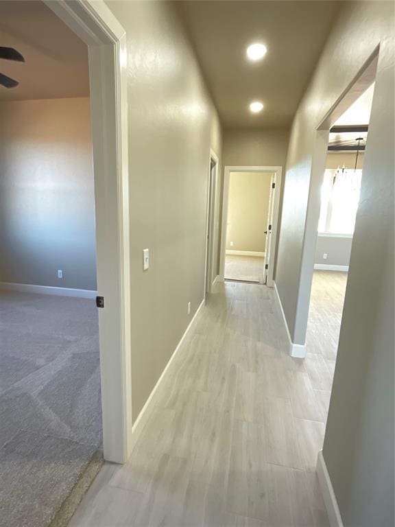 corridor with recessed lighting, baseboards, and light wood-style flooring