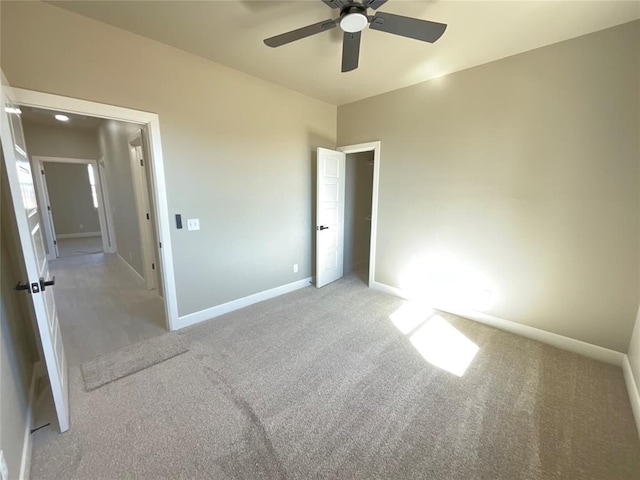 unfurnished bedroom with baseboards, a ceiling fan, and carpet flooring