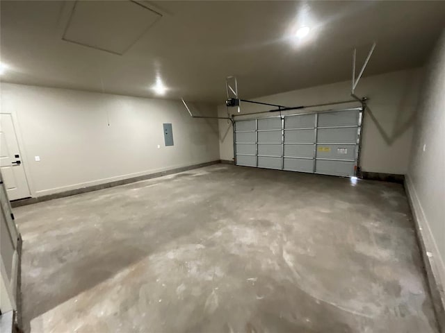 garage with baseboards, a garage door opener, and electric panel