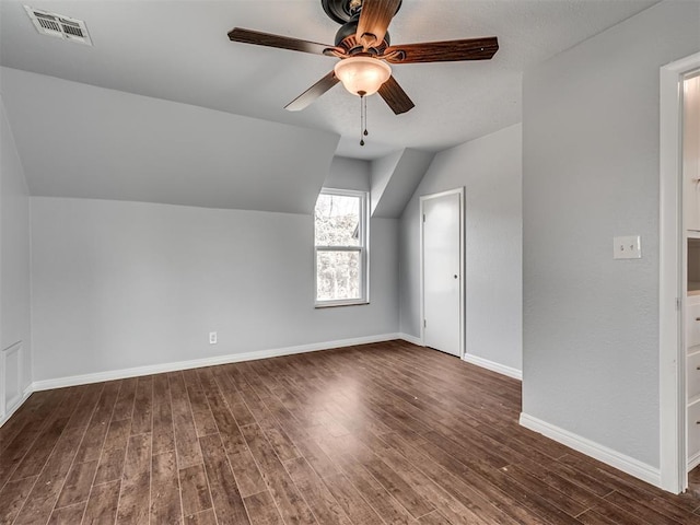 bonus room with ceiling fan, dark hardwood / wood-style floors, and lofted ceiling