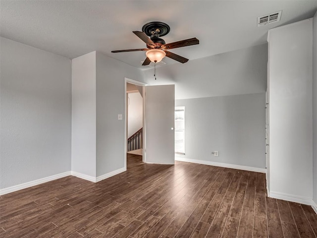 unfurnished room with ceiling fan, dark wood-type flooring, and lofted ceiling