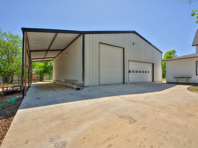 garage featuring concrete driveway and a detached garage