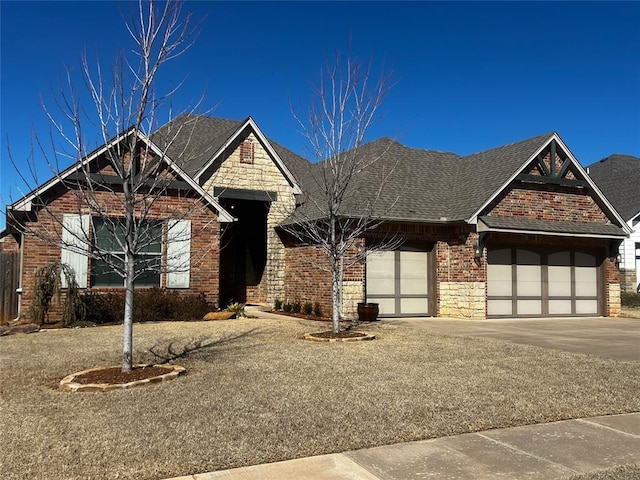 4309 NW 152nd Pl, Edmond, OK 73013 - view of front of property with brick siding, concrete driveway, a garage, and a shingled roof