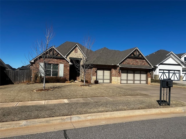 4309 NW 152nd Pl, Edmond, OK 73013 - view of front facade featuring brick siding, driveway, fence, and an attached garage